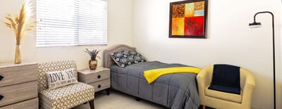 Cozy resident room with bed and furniture