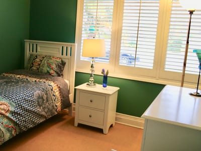 Cozy interior of a resident bedroom with green walls