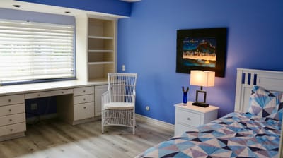 A well-furnished resident room with a calm color palette