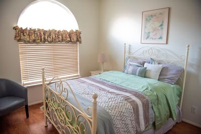 A well-furnished resident room with a bed and decor