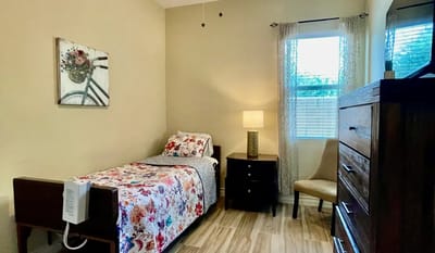 Cozy resident room with floral bedding and warm lighting