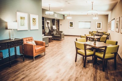 Lounge area with chairs and tables in a bright room