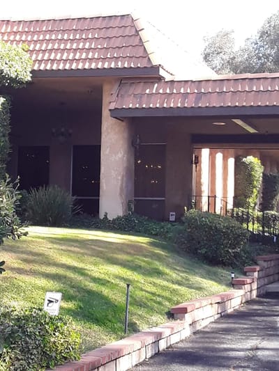 Exterior view of a senior living facility with landscaping