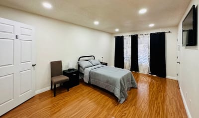 A private resident room with bed and furniture
