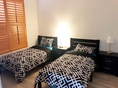 Private resident room with twin beds and lamp