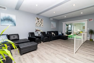 Bright common area with comfortable seating and art
