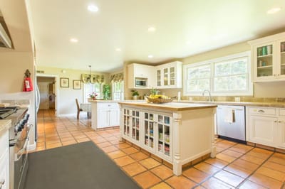 Bright and spacious kitchen area with white cabinets