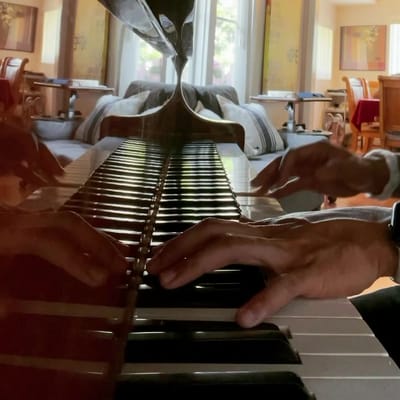 Person playing piano in a common area