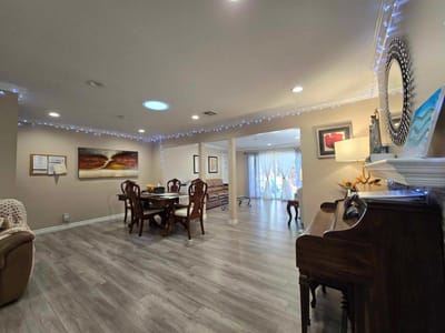 Bright common area with tables and piano