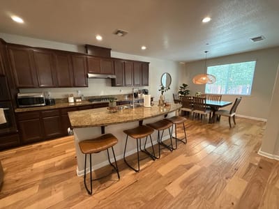 Bright interior kitchen and dining area with wood flooring