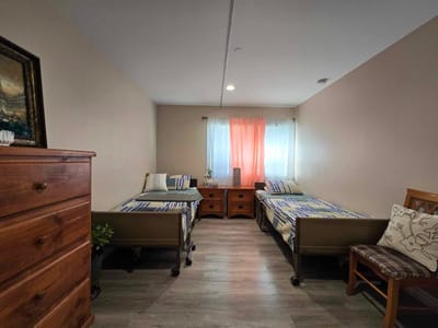 Private resident room with twin beds and a dresser