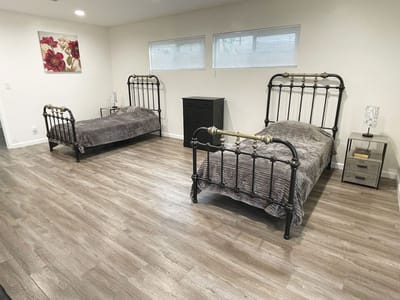 Private resident bedroom with two beds and modern decor