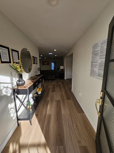 Bright interior hallway with plants and seating area