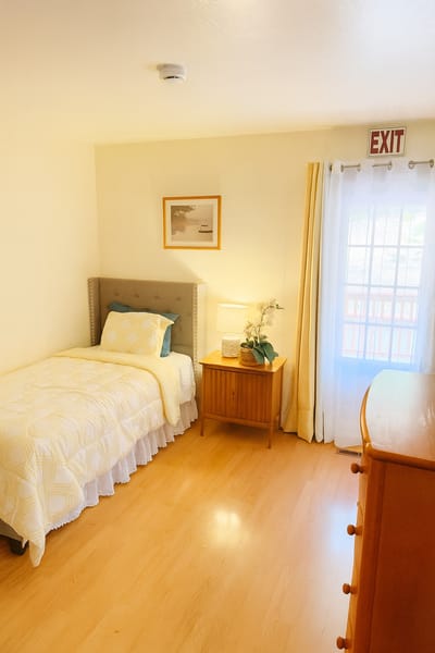 Cozy resident room with bed and dresser