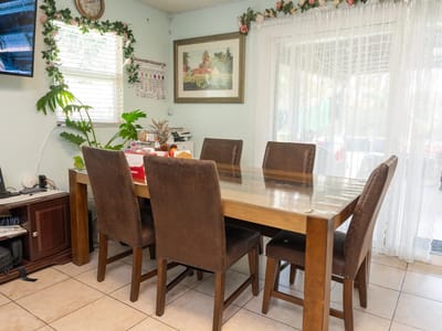A well-decorated dining area with a wooden table and chairs