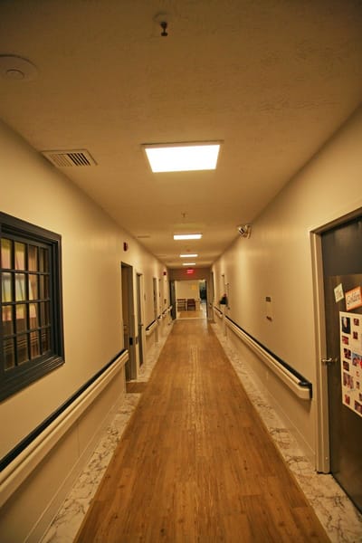 Bright, well-lit hallway in an assisted living facility