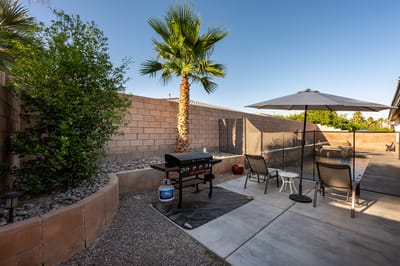 Outdoor patio area with seating and grill