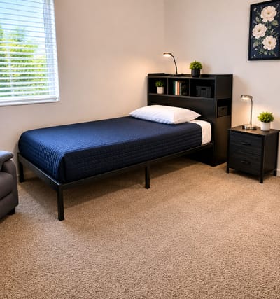 Comfortable private resident room with bed and furniture