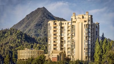 Exterior view of a senior living facility against a mountain backdrop