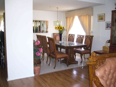 Dining area with wooden furniture and flowers