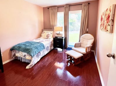 Cozy resident room with a bed and rocking chair