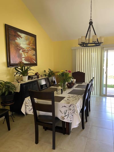Bright dining area with flowers and a table setting