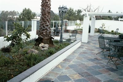 Outdoor patio area with seating and greenery