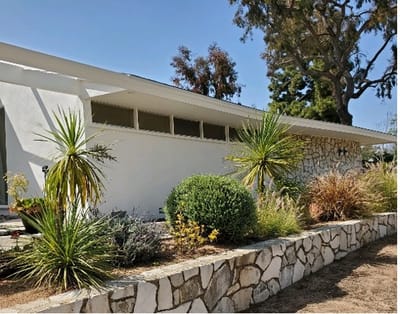 Exterior view of a facility with landscaped garden