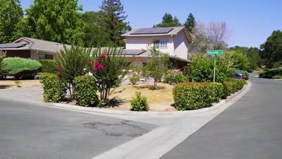 Exterior view of a residential care facility with greenery