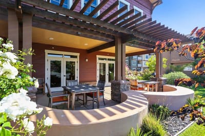 Outdoor seating area with tables and flowers