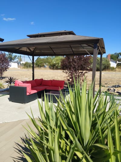 Outdoor seating area with a gazebo and lounge furniture