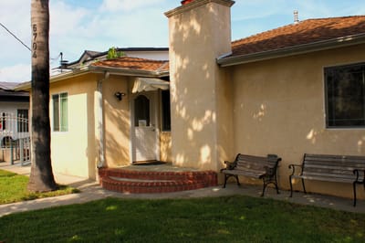 Exterior view of a residential building with seating area