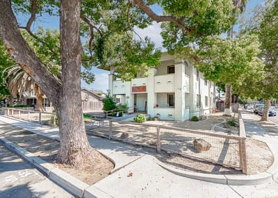 Exterior view of a senior living facility with trees