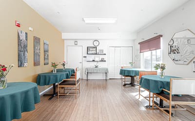 Common area with dining tables and floral arrangements