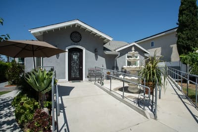 Exterior view of a senior care facility entrance with garden