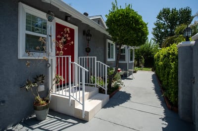 Entrance with steps leading into a vibrant outdoor space