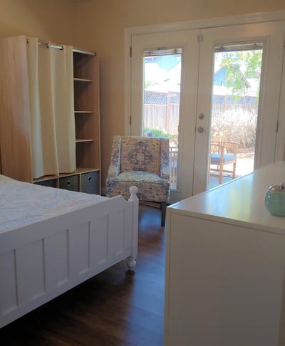 Bright interior of a resident room with patio access