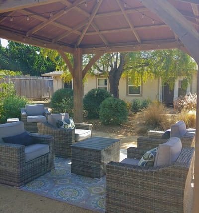 Outdoor seating area with comfortable furniture under a gazebo