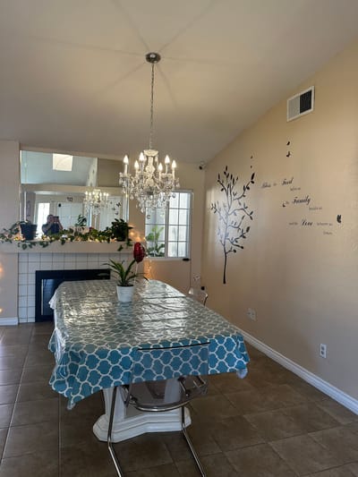 Bright dining area with chandelier and decor