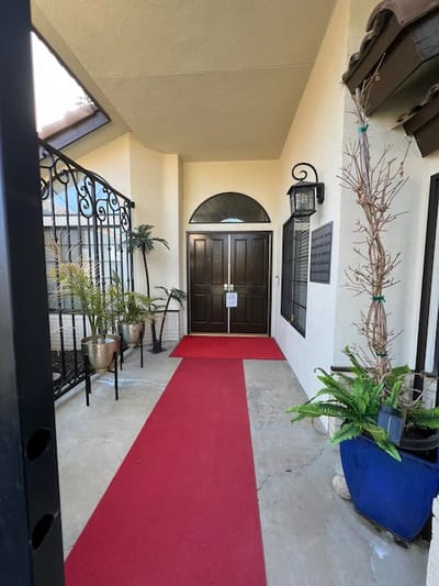 Entrance of a senior living facility with red carpet