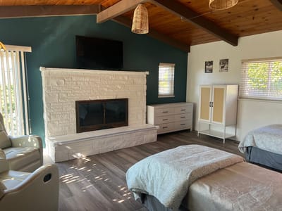 A cozy interior of a resident room with beds and decor