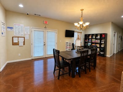 Common area with dining table and shelves