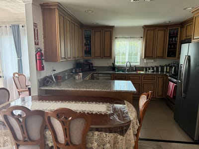 Bright kitchen area with dining table and cabinets