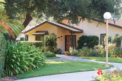 Exterior view of a facility entrance surrounded by landscaping