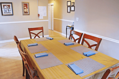 Dining area with a large table set for meals
