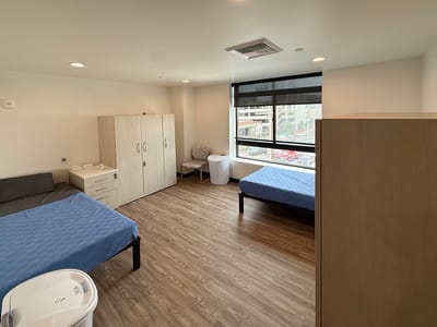 Bright interior of a shared resident room with two beds