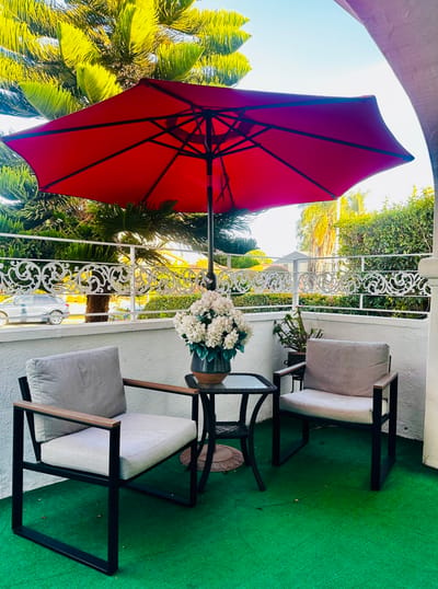 Outdoor seating area with flowers and an umbrella