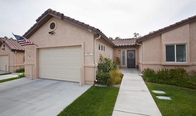 Exterior view of a senior living cottage with garden