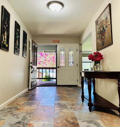 Bright corridor with floral decorations and exit sign