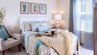 Cozy and well-decorated resident bedroom with food tray